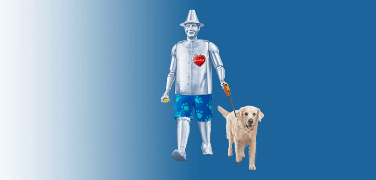 Man made of tin walking a golden retriever.
